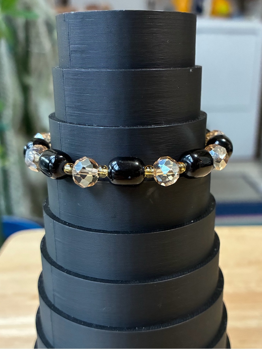 Black and Gold Beaded Stretch Bracelet with Iridescent Flower Charm - Picture 3 of 9